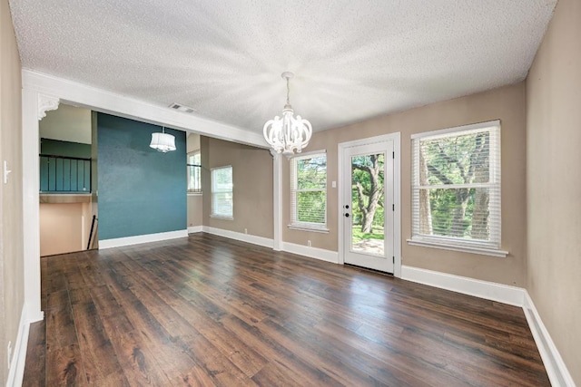 2505 Linwood Rd, Temple, TX 76502 - spare room featuring a chandelier, a textured ceiling, and dark wood finished floors