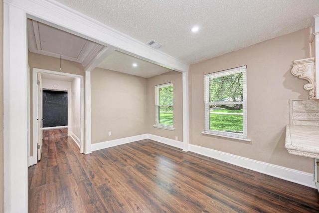 2505 Linwood Rd, Temple, TX 76502 - empty room with attic access, dark wood-style flooring, a textured ceiling, recessed lighting, and beamed ceiling