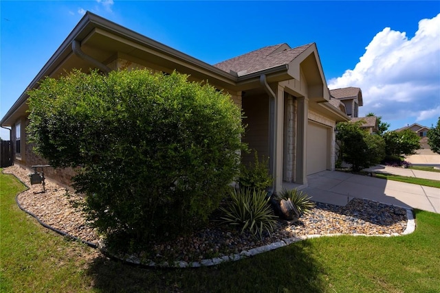 13903 Cantata Ln, Austin, TX 78660 - view of home's exterior with concrete driveway, a garage, and a yard