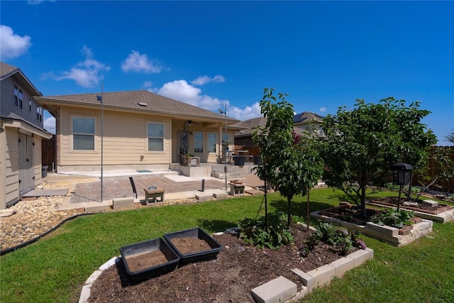 13903 Cantata Ln, Austin, TX 78660 - back of property featuring a patio area, a vegetable garden, and a fenced backyard