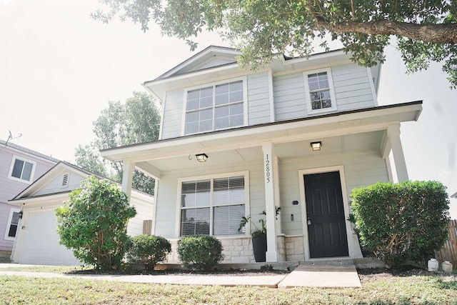12805 Briarcreek Loop, Manor, TX 78653 - view of front facade featuring a porch and a garage
