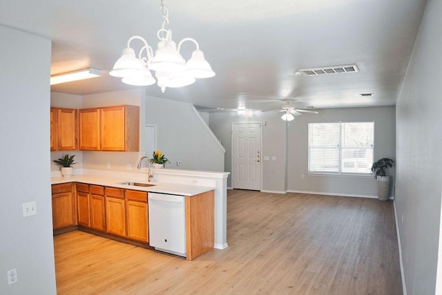 12805 Briarcreek Loop, Manor, TX 78653 - kitchen with white dishwasher, a chandelier, a peninsula, and light wood-style floors