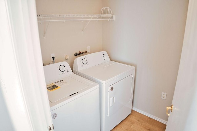 12805 Briarcreek Loop, Manor, TX 78653 - washroom featuring separate washer and dryer and light wood-style floors