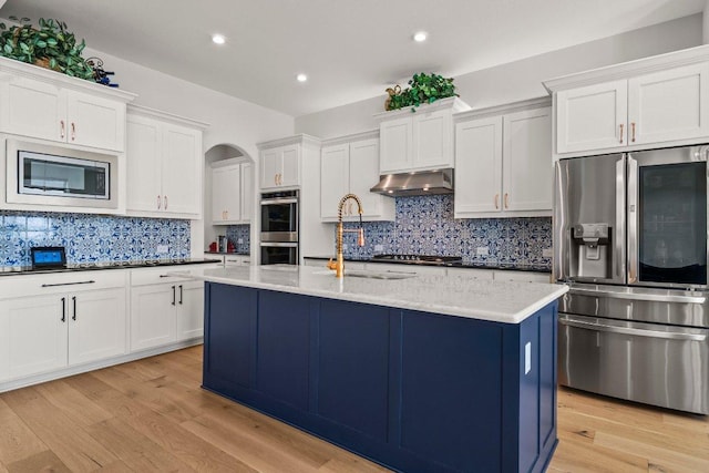 4509 Port Bari Dr, Leander, TX 78641 - kitchen featuring stainless steel appliances, under cabinet range hood, tasteful backsplash, white cabinetry, and recessed lighting