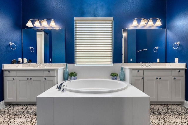 4509 Port Bari Dr, Leander, TX 78641 - bathroom featuring a garden tub, two vanities, and tile patterned flooring
