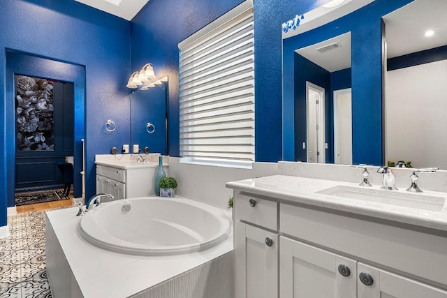 4509 Port Bari Dr, Leander, TX 78641 - bathroom featuring two vanities and a bath