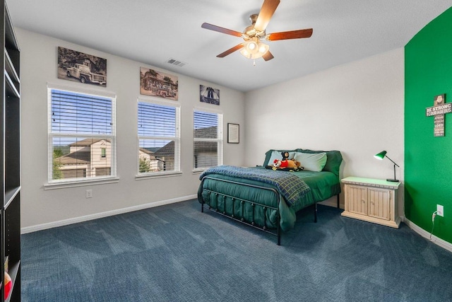 4509 Port Bari Dr, Leander, TX 78641 - bedroom with dark carpet, multiple windows, and a ceiling fan