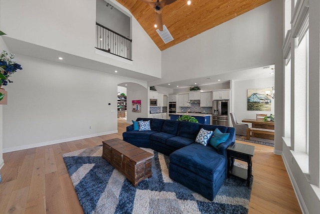 4509 Port Bari Dr, Leander, TX 78641 - living room with high vaulted ceiling, arched walkways, wooden ceiling, light wood-style flooring, and recessed lighting