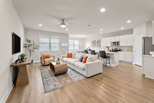 16941 Aventura Ave, Pflugerville, TX 78660 - living room with ceiling fan, light wood-type flooring, and recessed lighting