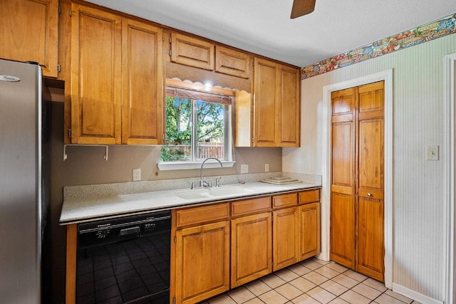 206 Woodland Trl, Belton, TX 76513 - kitchen featuring black dishwasher, freestanding refrigerator, light countertops, wallpapered walls, and brown cabinets