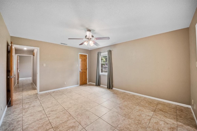 206 Woodland Trl, Belton, TX 76513 - unfurnished bedroom with a textured ceiling, a ceiling fan, and light tile patterned floors