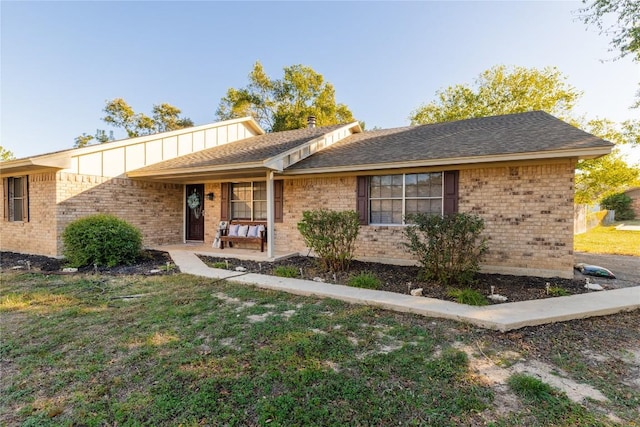 206 Woodland Trl, Belton, TX 76513 - ranch-style house with brick siding, a porch, a front yard, and board and batten siding