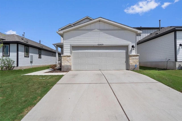 12003 Curlin Cv, Buda, TX 78610 - single story home featuring a front lawn, driveway, board and batten siding, an attached garage, and stone siding