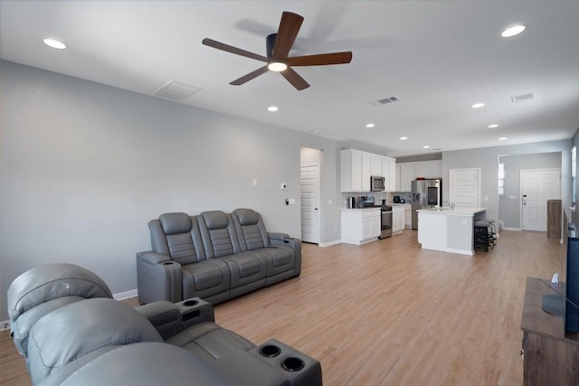 12003 Curlin Cv, Buda, TX 78610 - living area with ceiling fan, light wood-style flooring, and recessed lighting