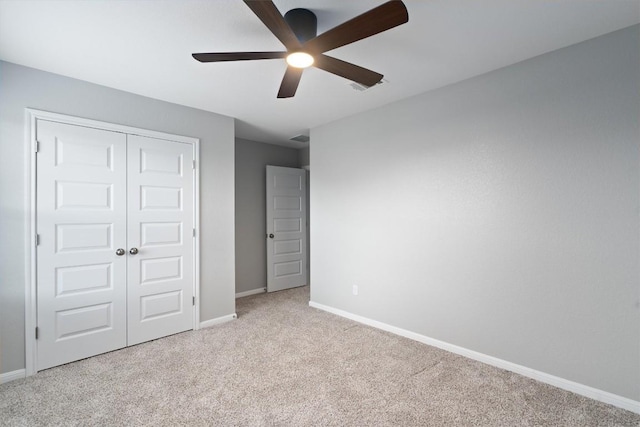 12003 Curlin Cv, Buda, TX 78610 - unfurnished bedroom featuring carpet flooring, a closet, and a ceiling fan