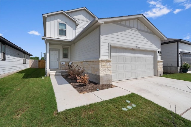 12003 Curlin Cv, Buda, TX 78610 - view of front of house with board and batten siding, a garage, concrete driveway, a front yard, and stone siding