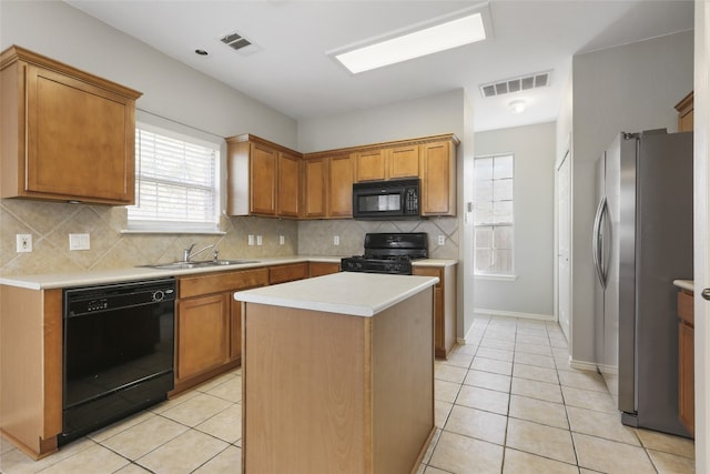 9405 Billingham Trl, Austin, TX 78717 - kitchen with black appliances, light tile patterned floors, light countertops, backsplash, and a kitchen island