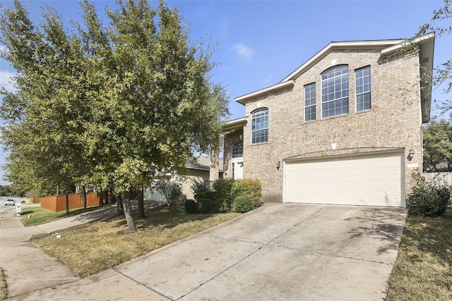 9405 Billingham Trl, Austin, TX 78717 - view of front of house featuring brick siding, an attached garage, and driveway