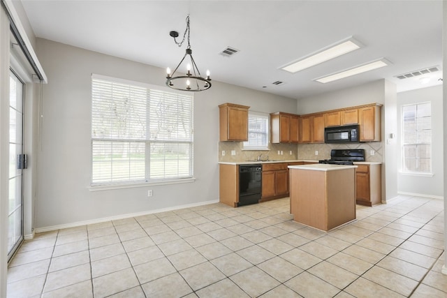 9405 Billingham Trl, Austin, TX 78717 - kitchen featuring black appliances, light countertops, decorative backsplash, a chandelier, and light tile patterned floors