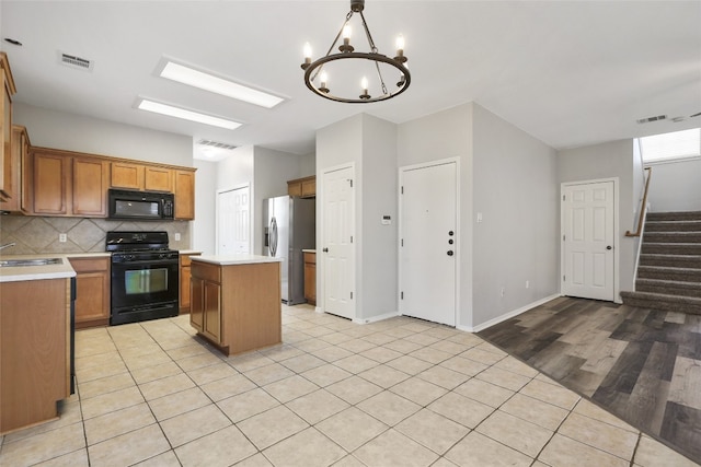 9405 Billingham Trl, Austin, TX 78717 - kitchen featuring black appliances, a kitchen island, light countertops, and tasteful backsplash