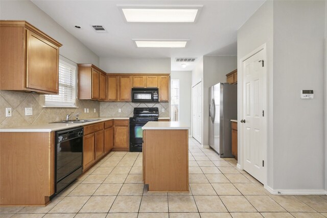 9405 Billingham Trl, Austin, TX 78717 - kitchen with black appliances, light countertops, a kitchen island, backsplash, and light tile patterned floors