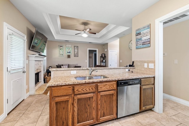 198 Sheridan Loop, Belton, TX 76513 - kitchen featuring dishwasher, open floor plan, brown cabinetry, a peninsula, and light tile patterned floors