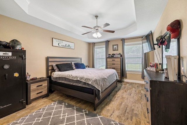 198 Sheridan Loop, Belton, TX 76513 - bedroom with a tray ceiling, light wood-type flooring, and a ceiling fan
