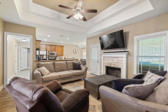 198 Sheridan Loop, Belton, TX 76513 - living area with a ceiling fan, a tray ceiling, a fireplace, crown molding, and recessed lighting