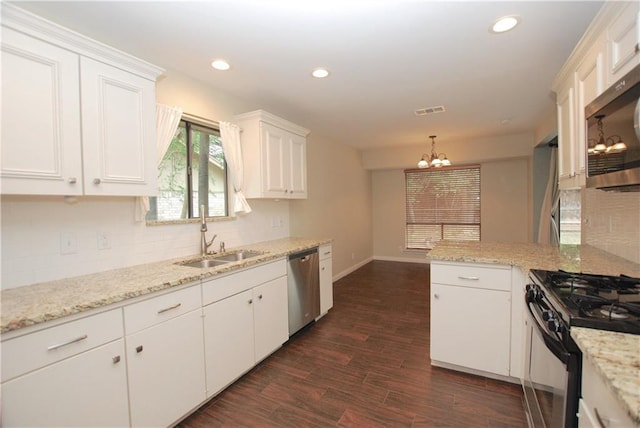 11724 Running Fox Trl, Austin, TX 78759 - kitchen featuring appliances with stainless steel finishes, a chandelier, white cabinets, dark wood finished floors, and backsplash