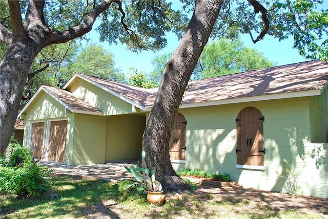 11724 Running Fox Trl, Austin, TX 78759 - view of side of home with brick siding and roof with shingles