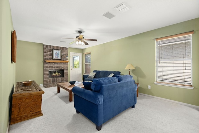 2127 Redwing Way, Round Rock, TX 78664 - living room with light carpet, ceiling fan, and a brick fireplace