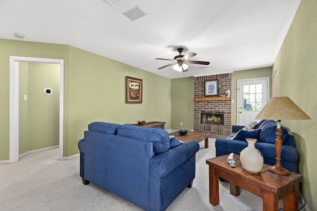 2127 Redwing Way, Round Rock, TX 78664 - living room with ceiling fan, light colored carpet, and a brick fireplace