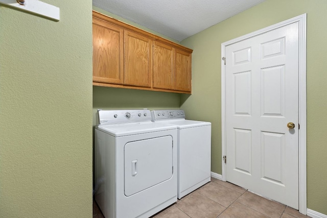 2127 Redwing Way, Round Rock, TX 78664 - washroom featuring washer and clothes dryer, cabinet space, light tile patterned floors, and a textured wall