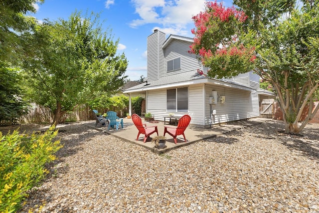2127 Redwing Way, Round Rock, TX 78664 - rear view of house featuring a patio, a fenced backyard, and a chimney