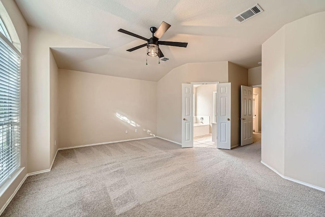 17714 Limpia Crk, Round Rock, TX 78664 - unfurnished bedroom with carpet floors, lofted ceiling, ensuite bath, and a ceiling fan