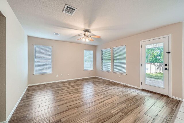 17714 Limpia Crk, Round Rock, TX 78664 - empty room with a ceiling fan, wood finished floors, and a textured ceiling
