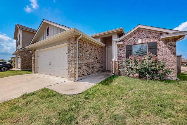12301 Amber Lynn Path, Manor, TX 78653 - view of front of property with board and batten siding, a garage, concrete driveway, brick siding, and a front lawn