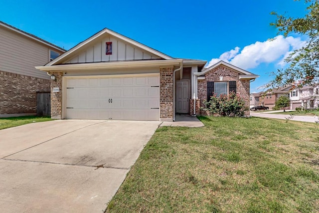 12301 Amber Lynn Path, Manor, TX 78653 - single story home with board and batten siding, driveway, a garage, a front yard, and brick siding