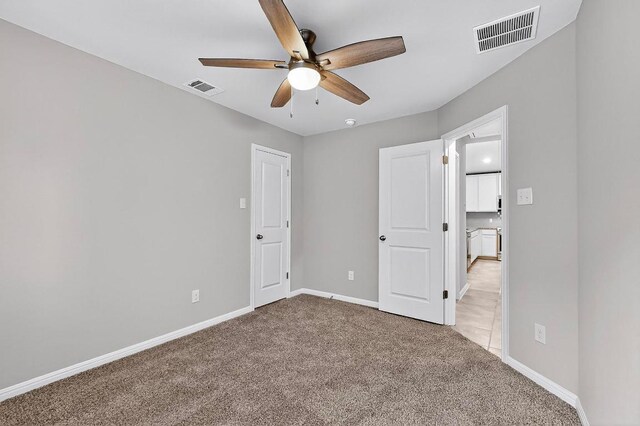 12301 Amber Lynn Path, Manor, TX 78653 - unfurnished bedroom with light colored carpet and ceiling fan
