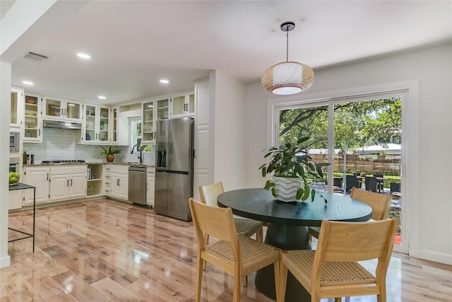 7806 Mullen Dr, Austin, TX 78757 - dining room with light wood-style flooring and recessed lighting