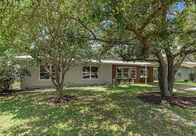 7806 Mullen Dr, Austin, TX 78757 - view of front of home featuring a front yard, driveway, and a carport