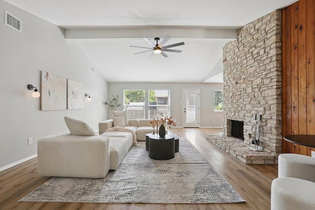 13101 Silver Creek Dr, Austin, TX 78727 - living area featuring beam ceiling, ceiling fan, wood finished floors, a fireplace, and high vaulted ceiling
