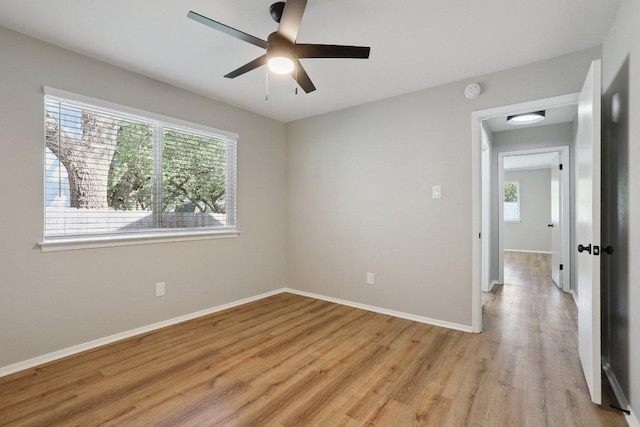 13101 Silver Creek Dr, Austin, TX 78727 - empty room with plenty of natural light, light wood-style floors, and a ceiling fan