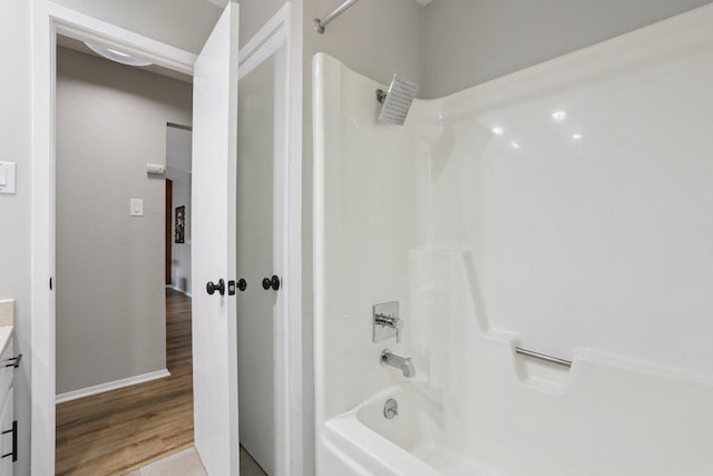 13101 Silver Creek Dr, Austin, TX 78727 - bathroom with bathing tub / shower combination, vanity, and wood finished floors