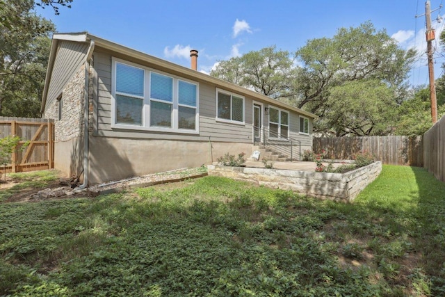 13101 Silver Creek Dr, Austin, TX 78727 - rear view of property featuring a fenced backyard and entry steps