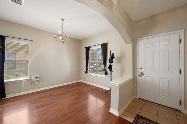 18112 Skysail Dr, Manor, TX 78653 - entrance foyer featuring arched walkways, a chandelier, and wood finished floors
