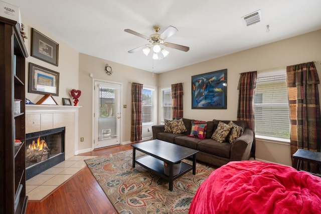 18112 Skysail Dr, Manor, TX 78653 - living room featuring a ceiling fan, a fireplace, and wood finished floors