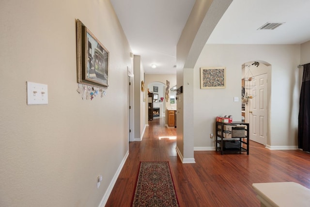 18112 Skysail Dr, Manor, TX 78653 - corridor with arched walkways and dark wood-type flooring