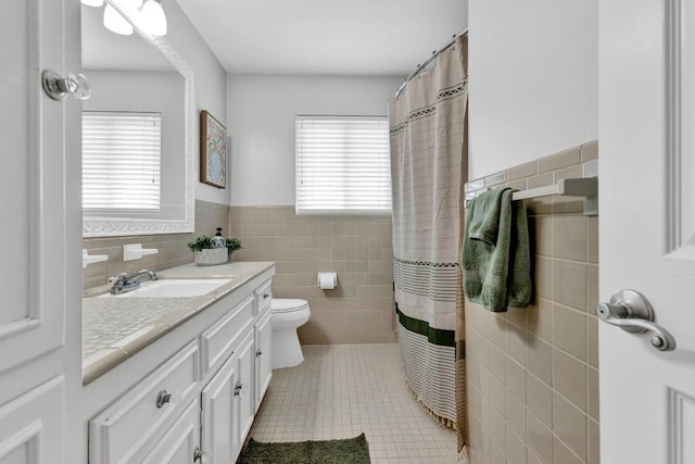 4001 Greystone Dr, Austin, TX 78731 - bathroom featuring tile walls, vanity, a wainscoted wall, tile patterned floors, and curtained shower