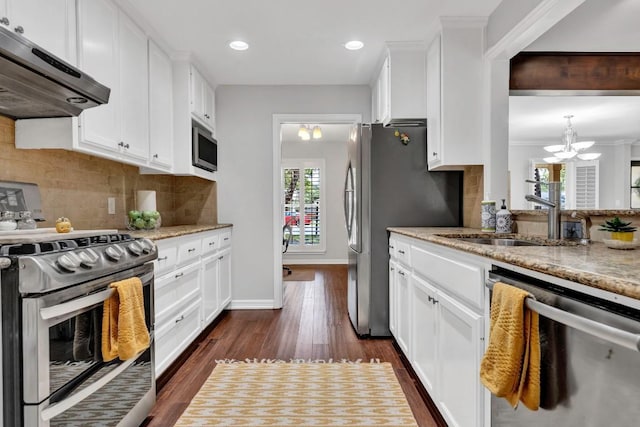4001 Greystone Dr, Austin, TX 78731 - kitchen featuring stainless steel appliances, ventilation hood, tasteful backsplash, white cabinets, and light stone counters